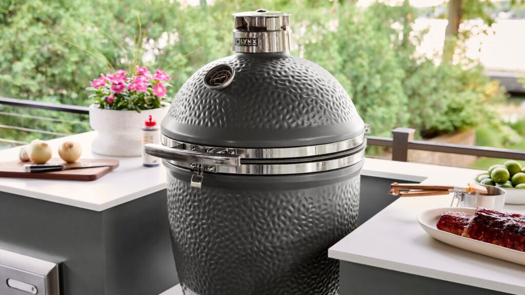 A Lynx kamado charcoal grill on a bright outdoor kitchen island