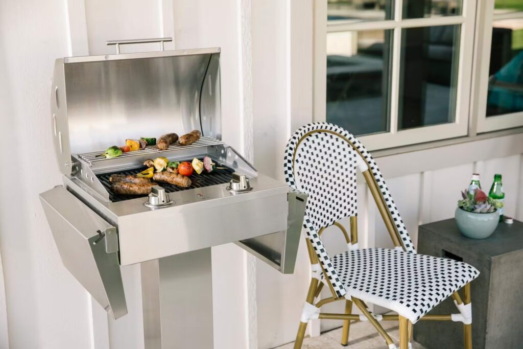 An electric grill cooking a full meal on a small patio