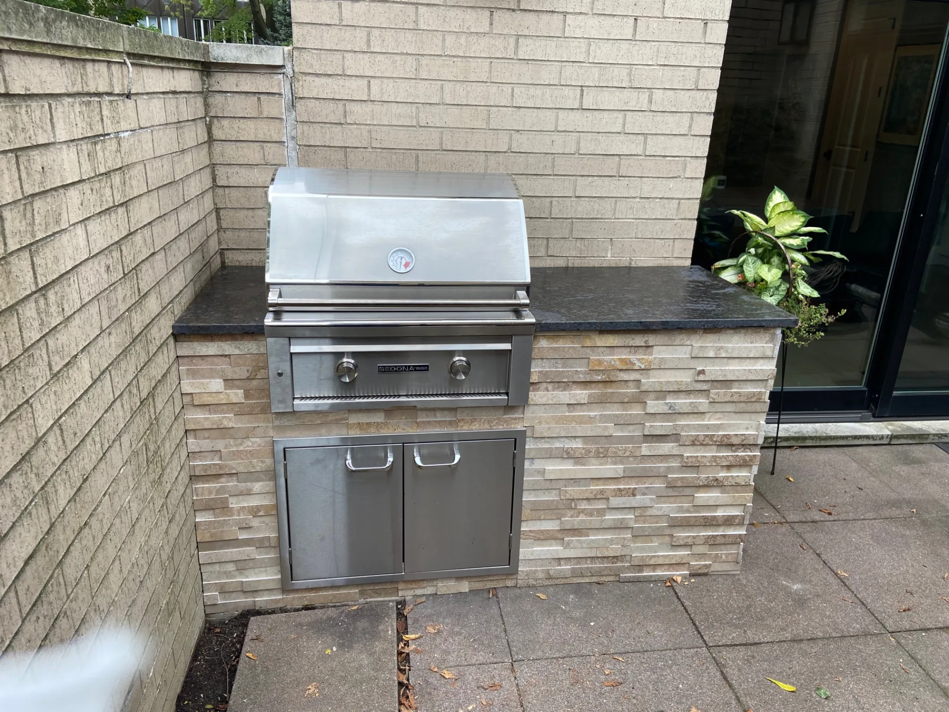 Completed stone outdoor kitchen project — total investment $10,148