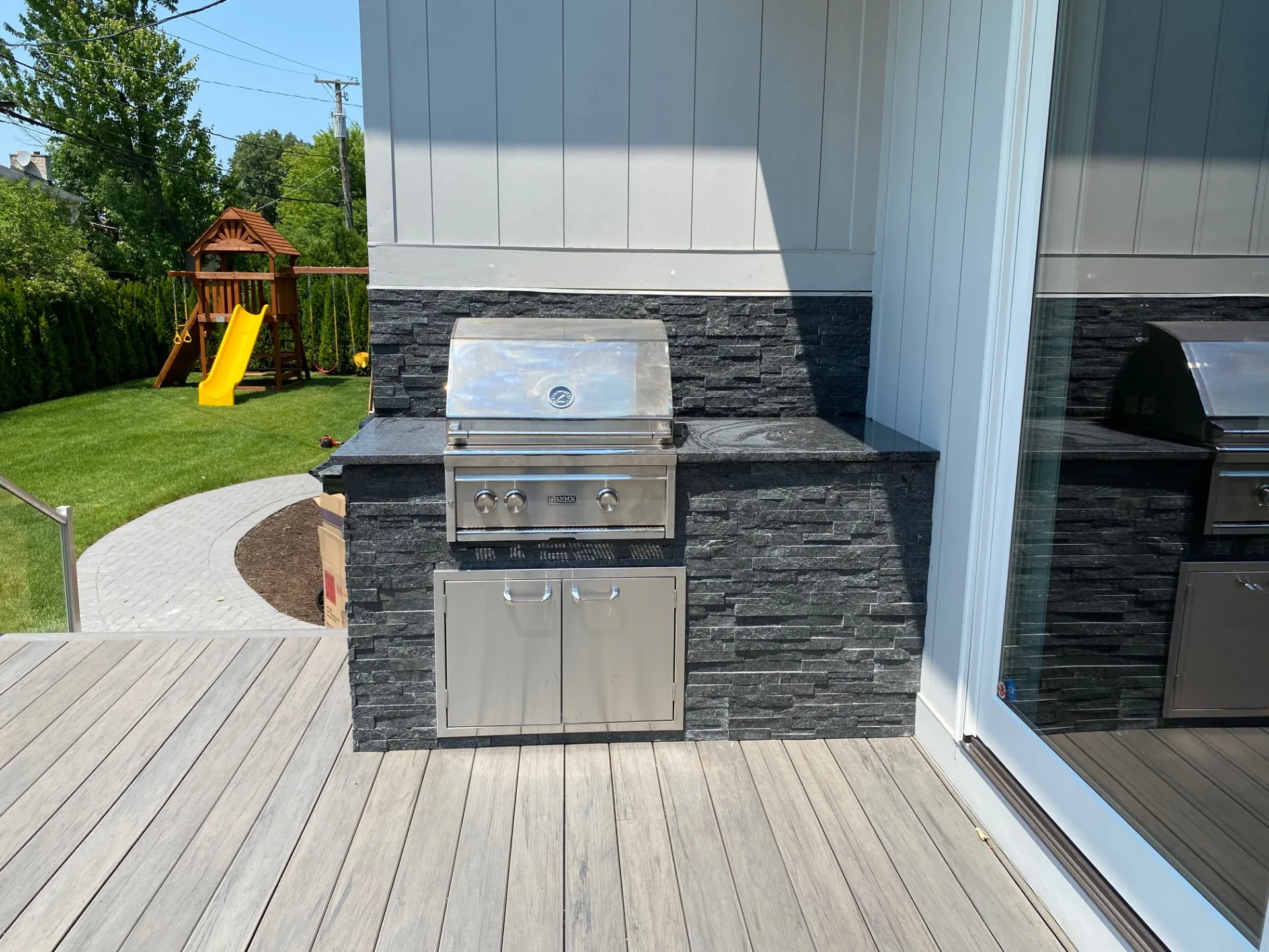 Completed stone outdoor kitchen project — total investment $12,988