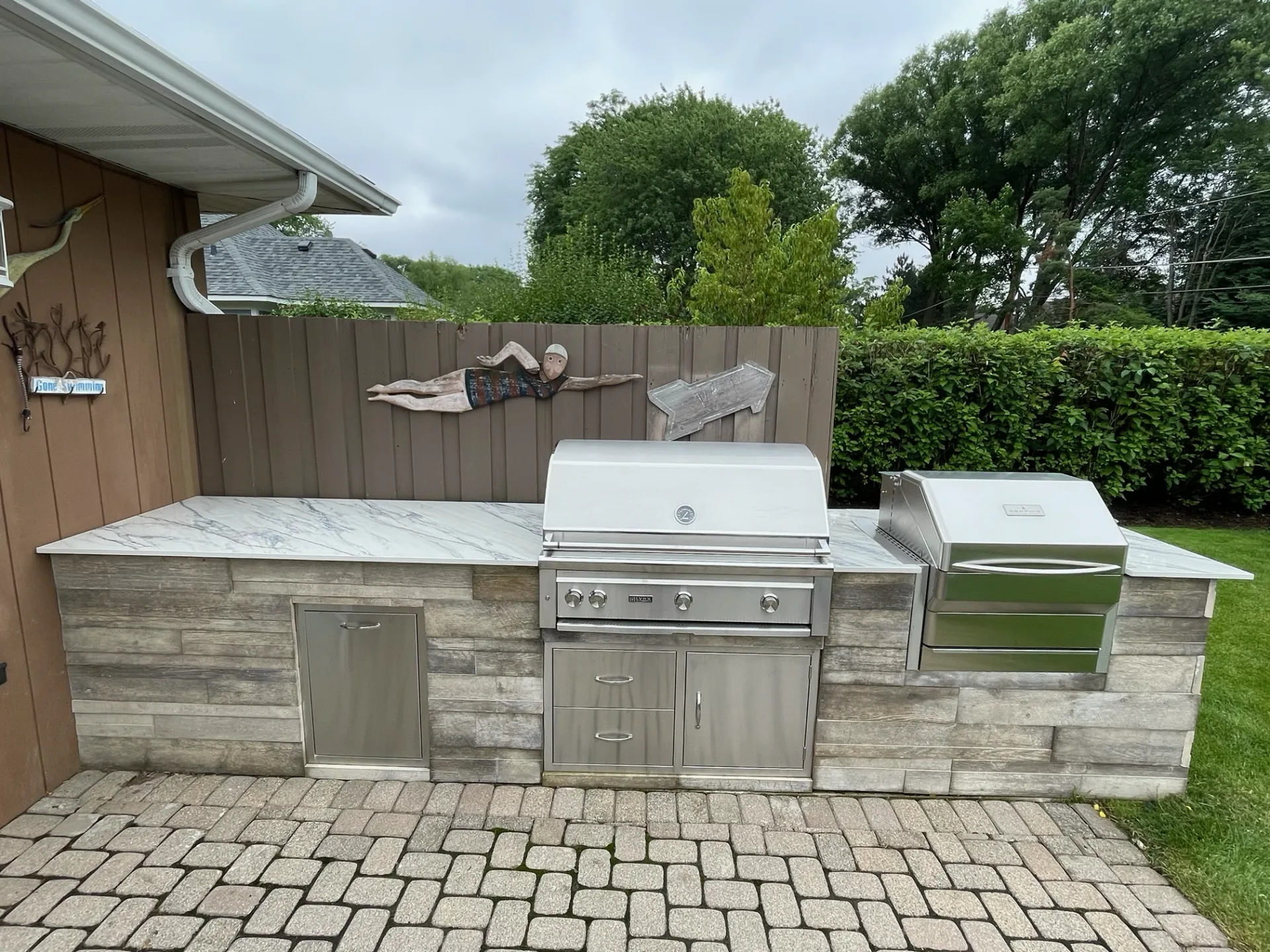 Completed stone outdoor kitchen project — total investment $30,607