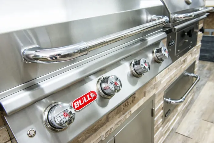 Close-up of a Bull built-in grill's control panel and burner knobs