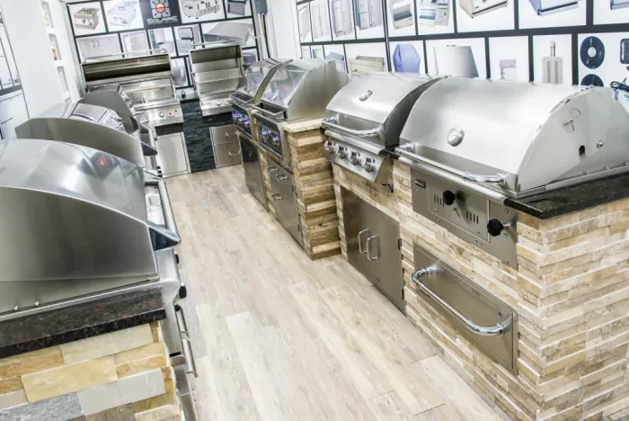 The full length of the showroom aisle, lined with built-in grills and outdoor kitchen islands