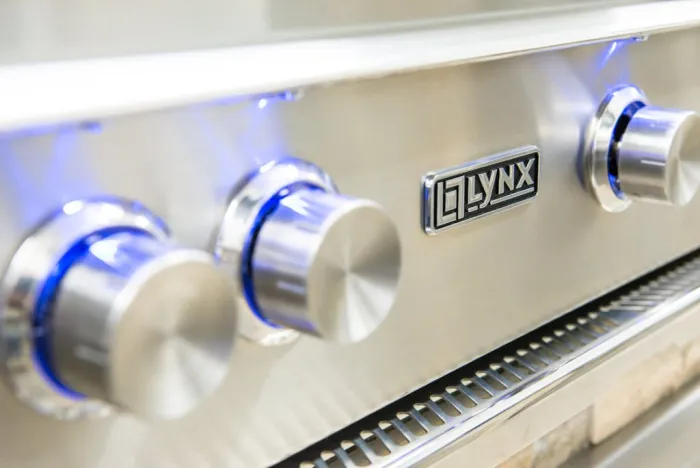 Lynx blue-lit control knobs and brand badge in close-up